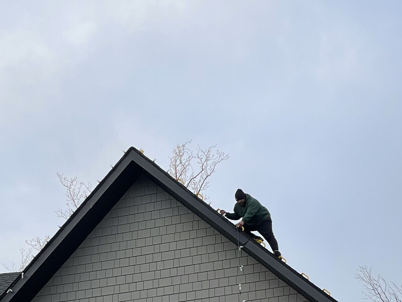 Holiday Lights Decor crew installing Christmas lights